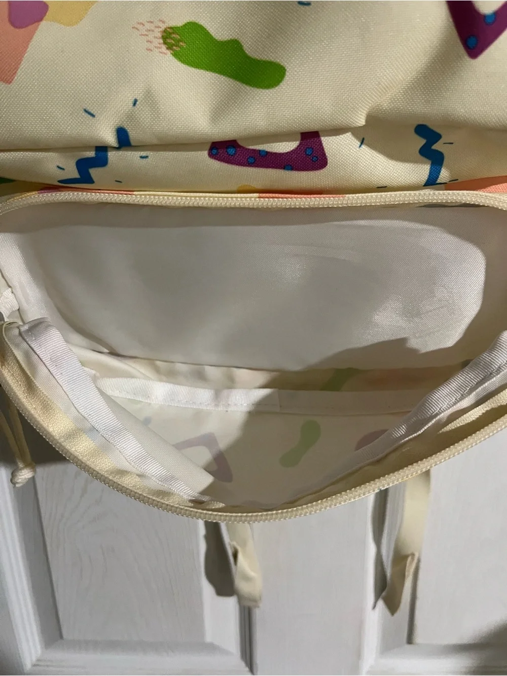 Jansport Cream Backpack with Multicolor Geometric Print